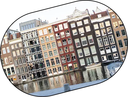 Rij van historische Nederlandse grachtenpanden met smalle gevels weerspiegeld langs de waterkant in Amsterdam.